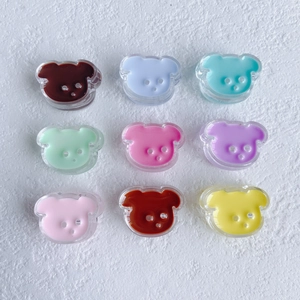 Macro shot of 9 colorful resin bear charms in a grid for DIY accessory making