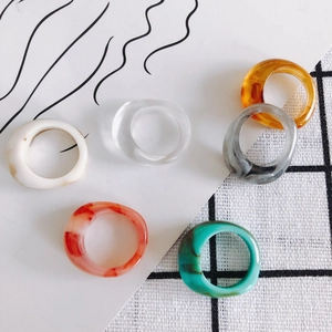 Set of six colorful resin acrylic rings with marble and translucent textured finishes