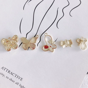 Gold butterfly and bow charms set for DIY jewelry making with polished metal finish