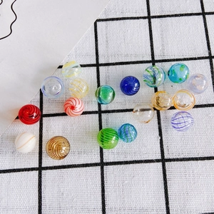 Detailed view of colorful spiral pattern glass beads for DIY jewelry making and crafts