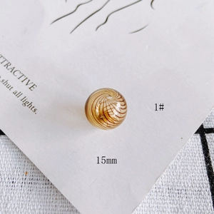 Macro detail of 15mm amber glass bead with brown swirl pattern for DIY jewelry