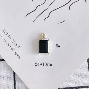 Macro view of 24x13mm DIY black rectangular pendant with gold prong setting and crystal