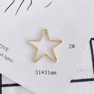 Detailed view of gold plated hollow star charm with 31x31mm dimensions for jewelry DIY