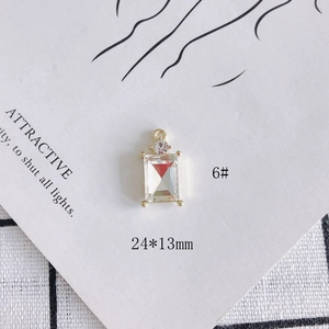 Macro detail of a 24x13mm gold-plated rectangular faceted crystal pendant charm