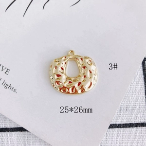 Detail of 25x26mm golden hammered star charm with hollow center for DIY jewelry making