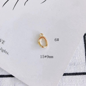 Macro view of a 15x9mm gold plated oval metal pendant for DIY jewelry making