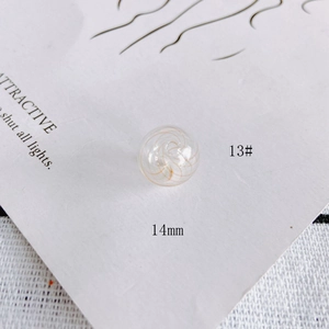 Detail of a 14mm hollow clear glass bead with orange spiral texture for DIY jewelry