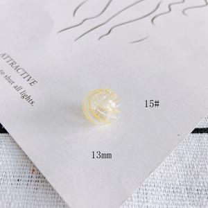 Macro shot of 13mm transparent glass bead with yellow spiral wave patterns for DIY jewelry