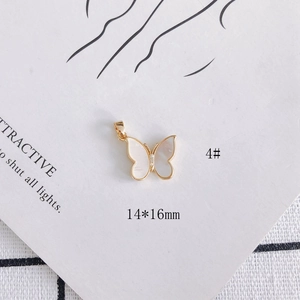 Macro detail of 14x16mm butterfly pendant with 18k gold plating and shell inlay