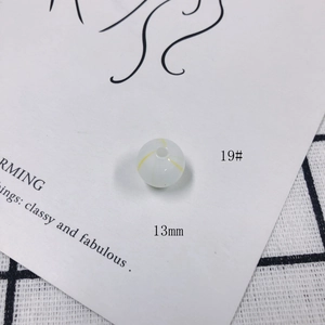 Macro detail of 13mm translucent glass bead with yellow ripple pattern for DIY jewelry