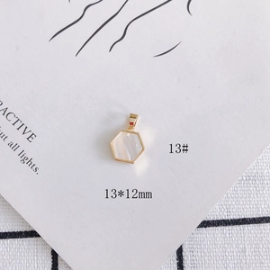 Detailed view of a 13x12mm hexagonal 18k gold-plated shell pendant with a pearly finish