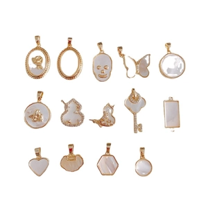 Assorted 18k gold plated shell pendants including skull and butterfly shapes