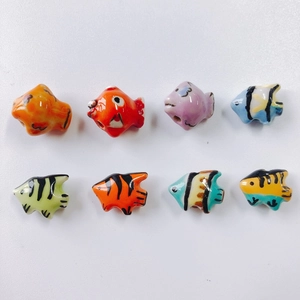 Macro shot of assorted colorful handmade ceramic fish beads for DIY jewelry making