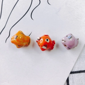 Hand-painted ceramic fish beads in orange, red and purple for DIY jewelry making