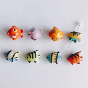 Macro shot of colorful ceramic tropical fish beads with pre-drilled holes for DIY jewelry
