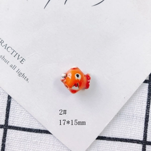 Close-up of orange handmade ceramic fish bead style 2 measuring 17x15mm for DIY jewelry