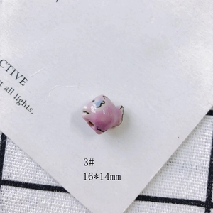 Macro shot of 16x14mm pink ceramic fish bead for DIY jewelry making and earrings