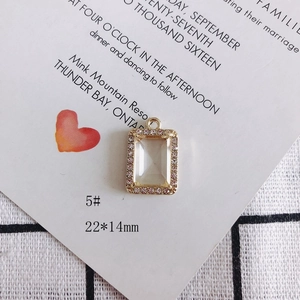 Detalle de un colgante rectangular de 22x14mm bañado en oro con diamantes morados
