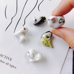 Handcrafted ceramic mini animal charms featuring cute cartoon sheep and penguin designs