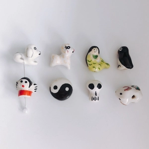 Macro shot of colorful handmade ceramic animal charms for DIY jewelry and accessories