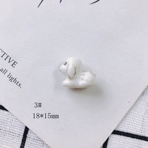 Detailed macro view of a 18x15mm puppy-shaped ceramic pendant with marble texture