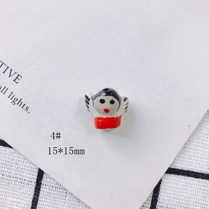 Detail of a 15x15mm handmade ceramic cartoon angel bead for DIY jewelry making