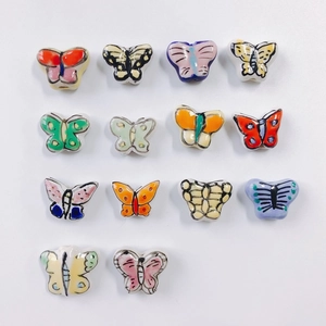 Macro view of assorted colorful butterfly ceramic beads with glazed finish for DIY jewelry