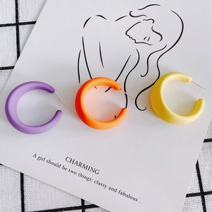 Colorful matte acrylic C-shaped hoop earrings in purple, orange, and yellow set