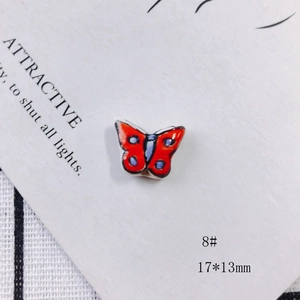 Detail of red butterfly ceramic bead 17x13mm with blue dots for DIY jewelry making