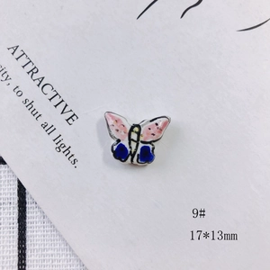 Macro view of a 17x13mm colorful butterfly ceramic bead for DIY jewelry making
