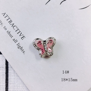Detail of 18x15mm handmade ceramic butterfly bead in pink and white for DIY jewelry