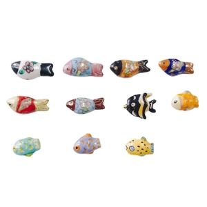 Collection of handmade colorful floral ceramic fish beads for DIY jewelry and crafts