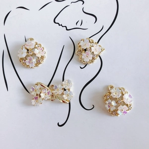 Light gold DIY jewelry pendants with iridescent flowers and sparkling rhinestones
