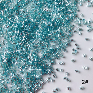 Macro detail of 2mm silver-lined light blue glass bugle beads for DIY jewelry making