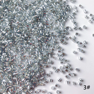 Close-up of 2mm silver-plated glass bugle beads for DIY jewelry and embroidery