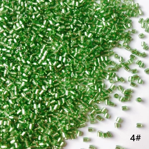 Macro shot of transparent green 2mm tube beads for DIY jewelry making and handmade crafts