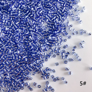 Macro shot of silver-lined blue 2mm glass tube beads for handmade DIY jewelry making
