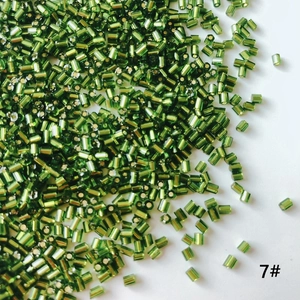 Macro shot of 7# olive green bugle beads with ribbed texture for jewelry DIY