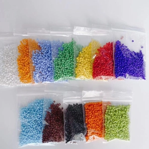 Vue détaillée de 12 sachets de perles de rocaille colorées de 2mm en verre pour bijoux