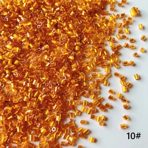 Macro detail of 2mm orange transparent glass tube beads for DIY jewelry making accessories