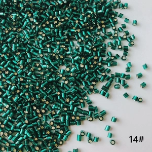Macro detail of 2mm dark green metallic seed beads number 14 for DIY jewelry making