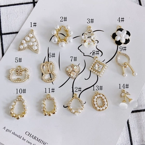 Selection of 14 gold plated jewelry pendants with pearls and rhinestones on card