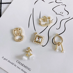 Elegant gold-plated pendants featuring pearl rabbits and floral motifs on white card