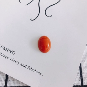 Macro detail of polished oval red acrylic resin beads for DIY shoe charms and phone cases