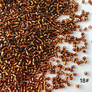 Macro detail of 2mm amber brown silver-lined glass bugle beads for DIY jewelry making