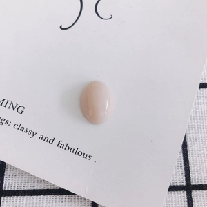 Close-up of smooth oval pink resin stone bead for DIY shoe charms and phone case art