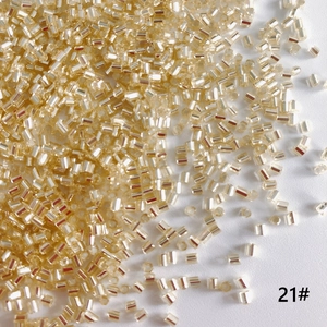 Close-up of 2mm silver-lined bugle beads in champagne gold for DIY jewelry making