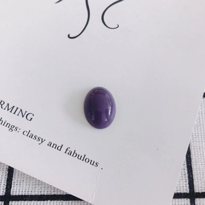 Detailed macro view of a polished purple oval cabochon for DIY jewelry and phone cases