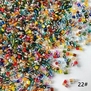 Macro view of colorful 2mm bugle beads with metallic silver lining for DIY jewelry