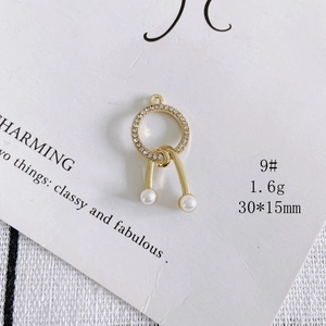 Close-up of elegant gold plated crystal pave round pendant with white pearls